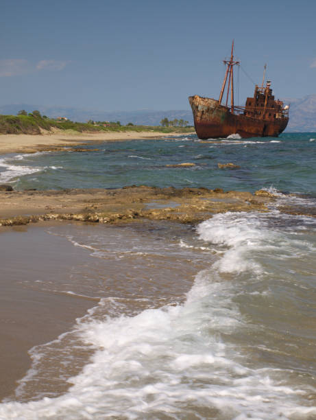 istock Big rusty wreck of a ship on beautiful sunny beach 1129403640