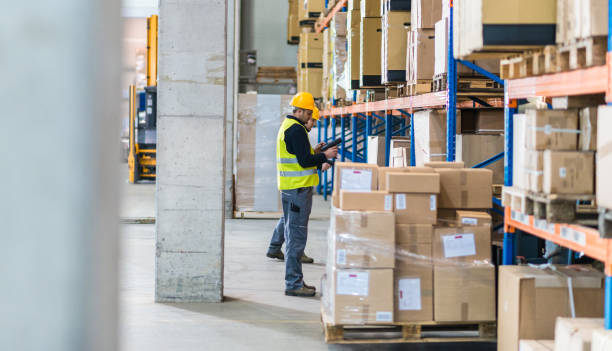 istock Male Warehouse Employee Doing Inventory Check In Warehouse 1129403681