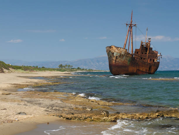 istock Rusty wreck of a ship, at a beautiful beach. 1129403904