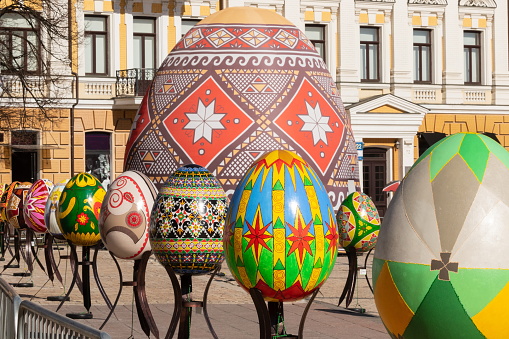 KYIV. UKRAINE - APRIL 07 2018: The Easter Festival in Kyiv on Sofiyvska Square. Artists display painted multicolored Easter eggs. Against the background of a historic building. Warm spring sunny day.