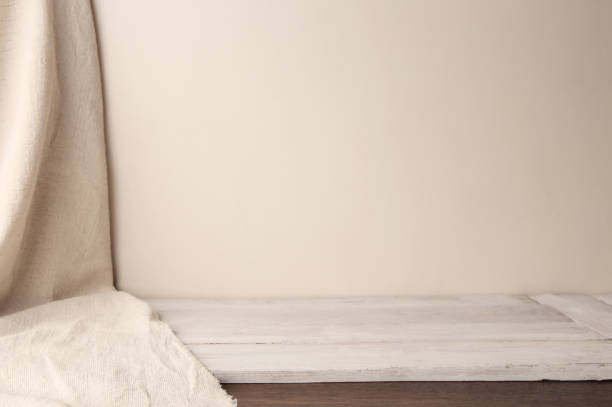 istock Background of white cloth on wooden planking and empty wall. 1129407597