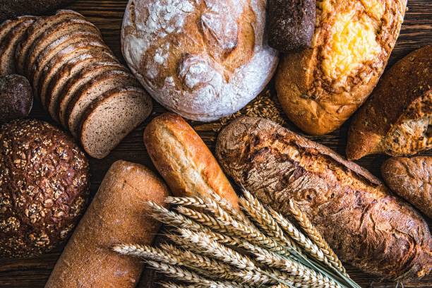 still life with breads and wheats - pao imagens e fotografias de stock