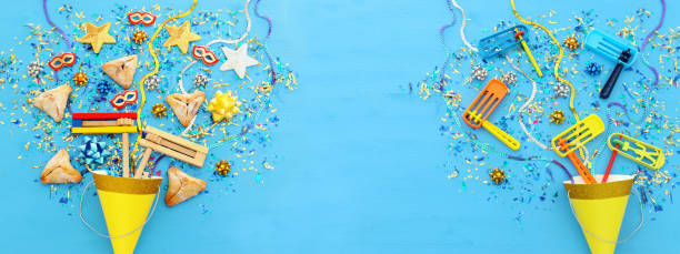 istock Purim celebration concept (jewish carnival holiday) over wooden blue background. Banner. 1129410047