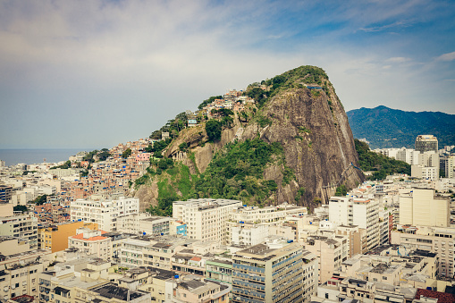 Monolith granite rock formation with favela in Rio de Janeiro, Brazil.