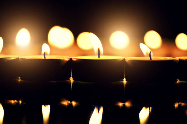 istock Close-Up Of Burning Tea Light Candles 1129411941