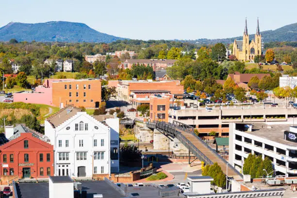 Photo of Small Town With Buildings, Rooftops And St. Andrews Catholic Church In The Background -- Roanoke Virginia