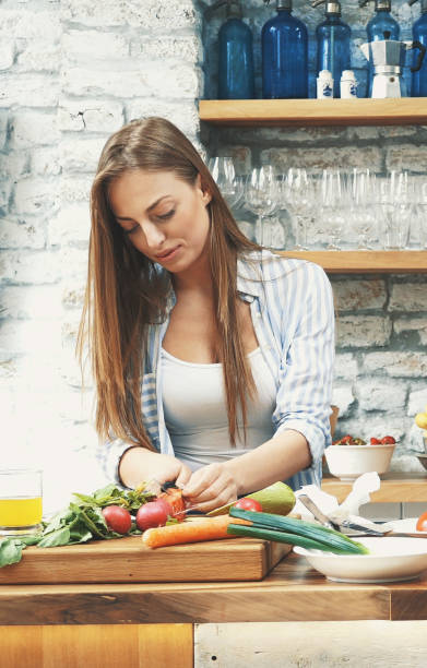 istock Young couple making dinner together at home 1129414541
