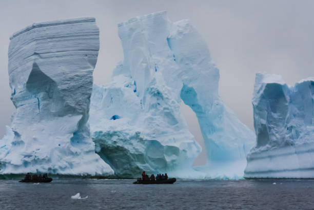 istock People on boats sailing along icebergs. 1129414913