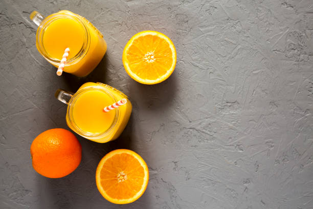 istock Fresh orange juice in glass jars, top view. From above, overhead. Copy space. 1129415290
