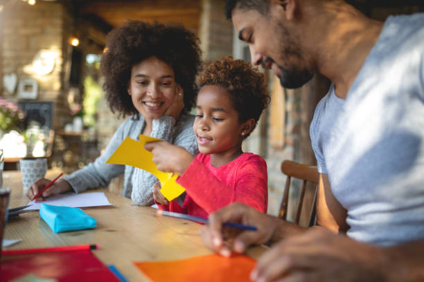 istock Cheerful family doing a art project together 1129415342