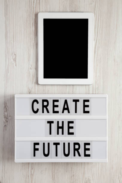 istock 'Create the future' word on modern board, tablet on a white wooden background, top view. From above, flat lay, overhead. 1129415353