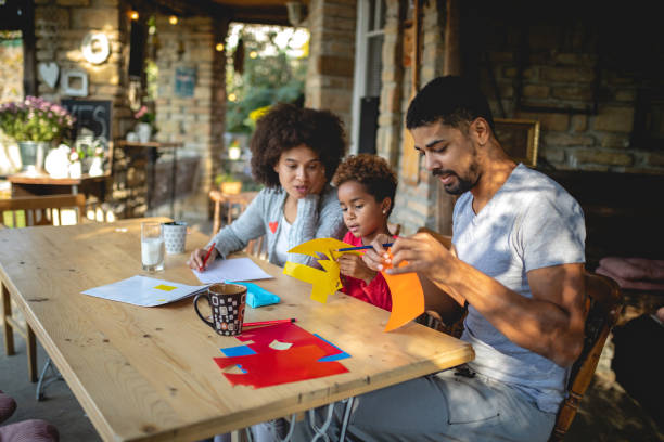 istock Family of three doing a art project for school 1129416724