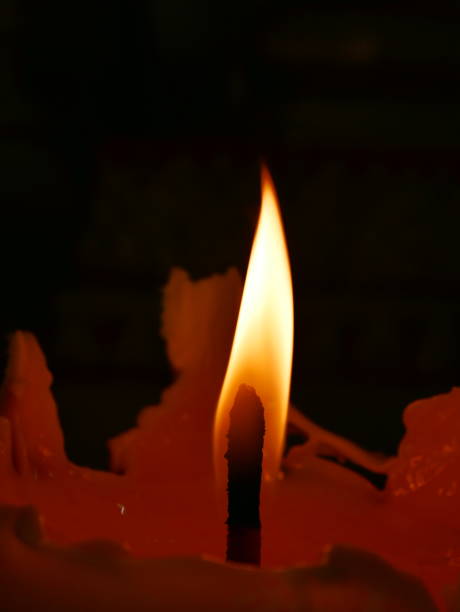 istock Candles Burning in the Dark with focus 1129418992