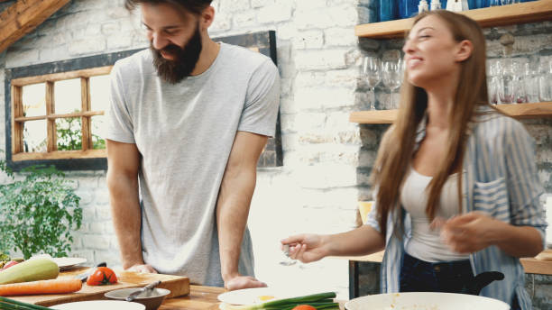 istock Young couple making dinner together at home 1129419565