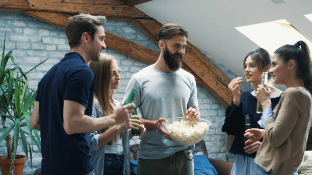 istock Girl feeding her friend with popcorn 1129419585