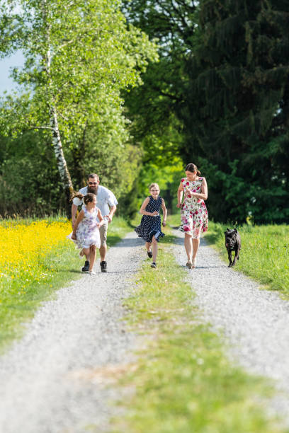 istock Family running outdoors with the dog 1129419649