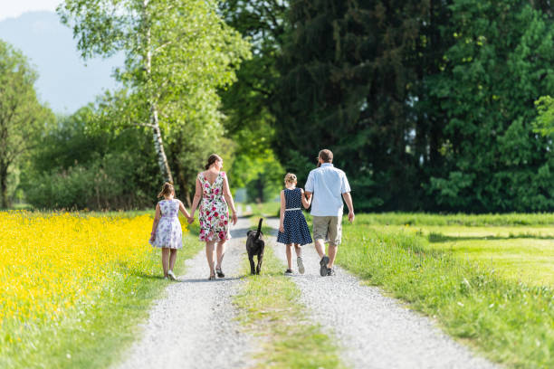 istock Family walking outdoors with the dog 1129419662