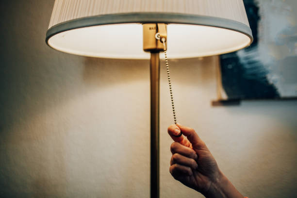 Turning off a lamp Turning off a lamp electric light stock pictures, royalty-free photos & images