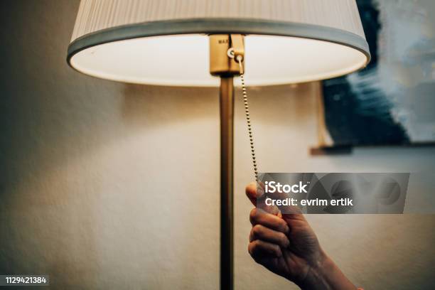 Turning Off A Lamp Stock Photo - Download Image Now - Turning On Or Off, Electric Light, Lighting Equipment