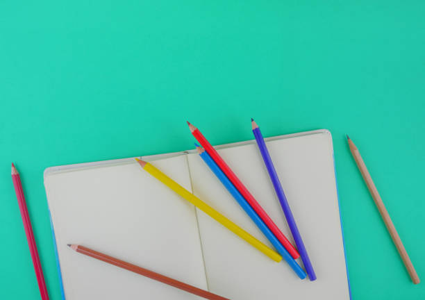 istock Flat lay,top view stationery including color pencils and notebook with copy space 1129421909