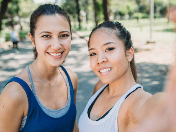 istock Young women taking a selfie together at the park while jogging 1129423965