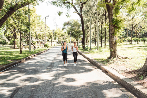 istock Young women running together at the park 1129423977