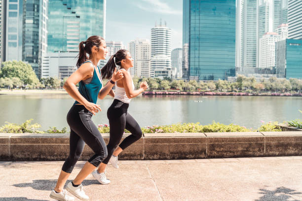 istock Young women running together at the park 1129423988