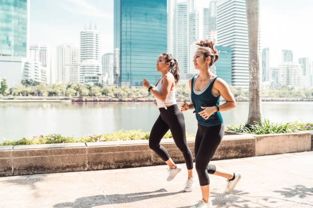 istock Young women running together at the park 1129424002