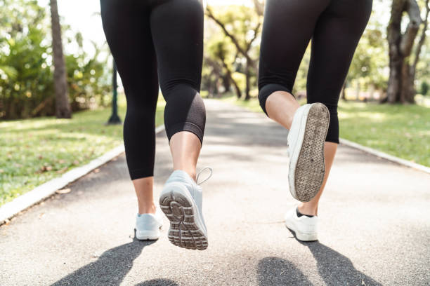 istock Young women running together at the park 1129424019