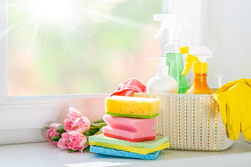 Spring cleaning concept - cleaning products, gloves, bokeh background, copy space