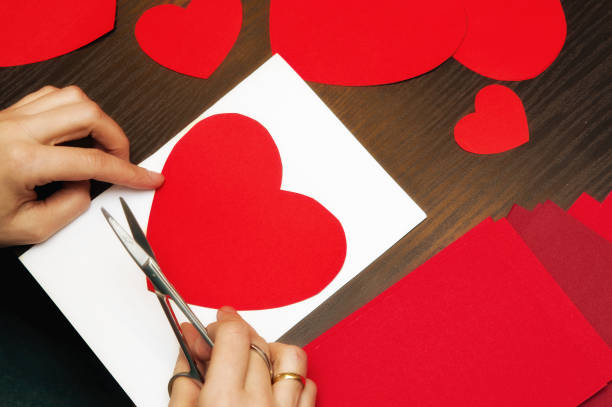 istock Woman doing Valentine's day paper cut-outs 1129426637