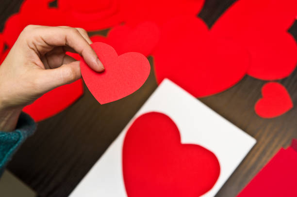 istock Woman doing Valentine's day paper cut-outs 1129426720