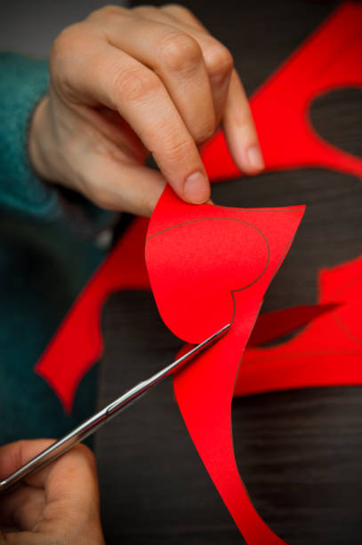 istock Woman doing Valentine's day paper cut-outs 1129426936