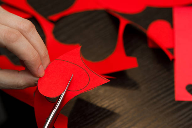 istock Woman doing Valentine's day paper cut-outs 1129426938