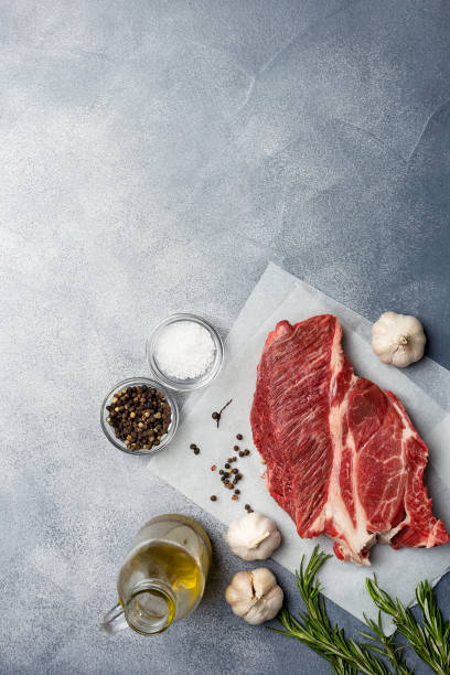 istock Fresh meat with ingredients at gray background 1129427586