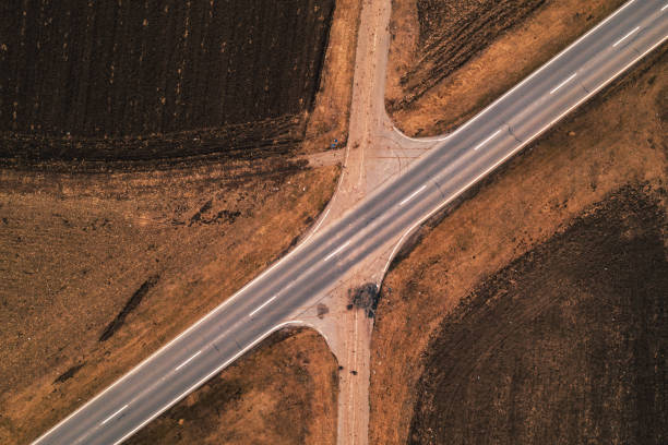 istock Aerial view of empty road through countryside landscape 1129428496