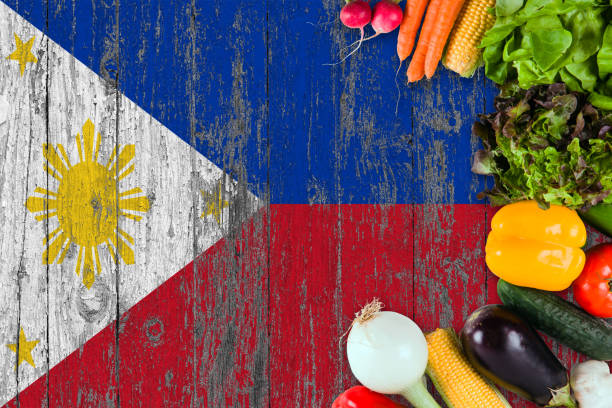 istock Fresh vegetables from Philippines on table. Cooking concept on wooden flag background. 1129428582