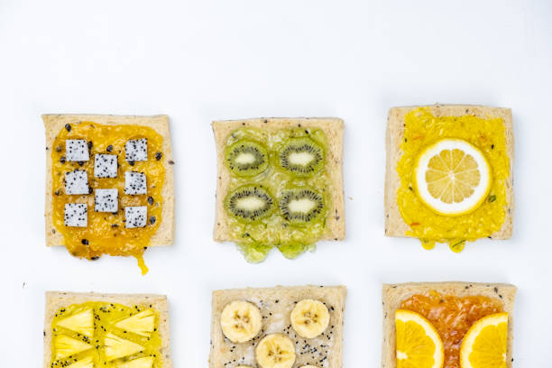 istock Delicious colourful minimal mix fruits jam on sliced bread. Set on white background. 1129430552