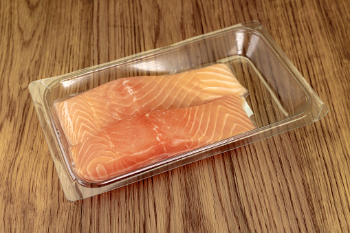 Plastic vacuum packed food. Two fillets of salmon.