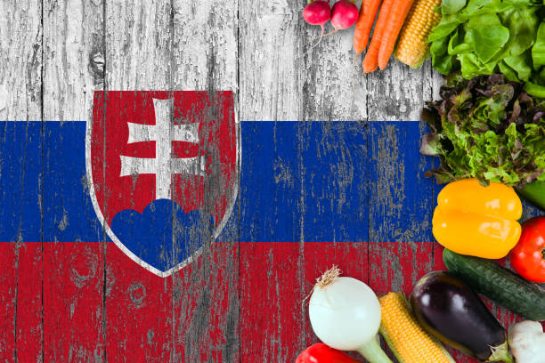 istock Fresh vegetables from Slovakia on table. Cooking concept on wooden flag background. 1129431942