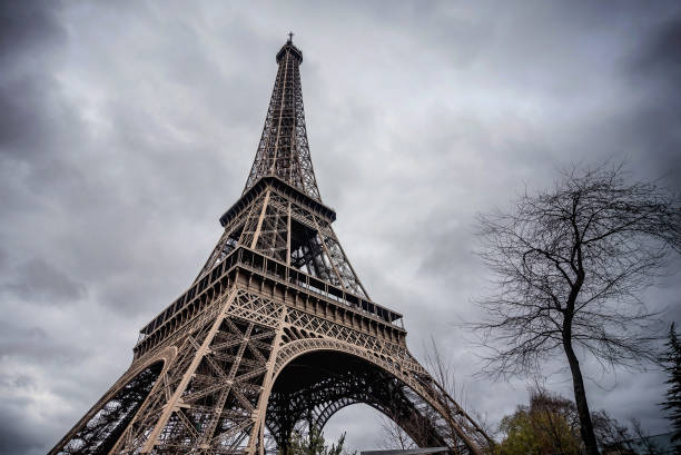 istock The Eiffel Tower with gray sky and clouds  in Paris, France 1129431978