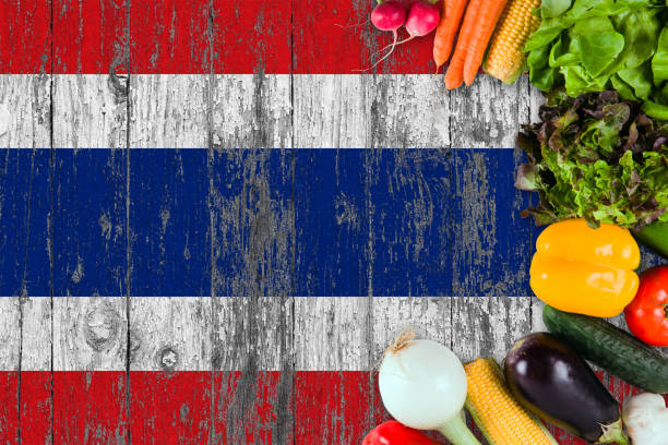 istock Fresh vegetables from Thailand on table. Cooking concept on wooden flag background. 1129432833