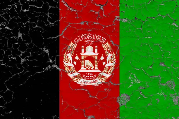 Photo of Flag of Afghanistan painted on cracked dirty wall. National pattern on vintage style surface.