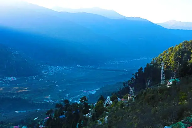 Mountain valley view with green trees and clear sky