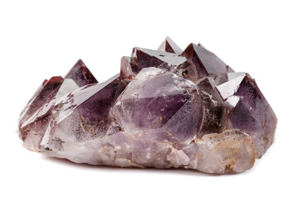 istock Macro mineral stone Amethysts, Goethite, Epidote on a white background 1129441635