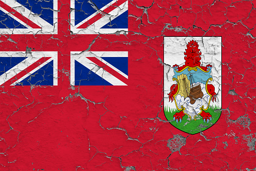 Flag of Bermuda painted on cracked dirty wall. National pattern on vintage style surface.