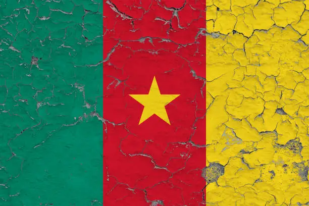 Photo of Flag of Cameroon painted on cracked dirty wall. National pattern on vintage style surface.