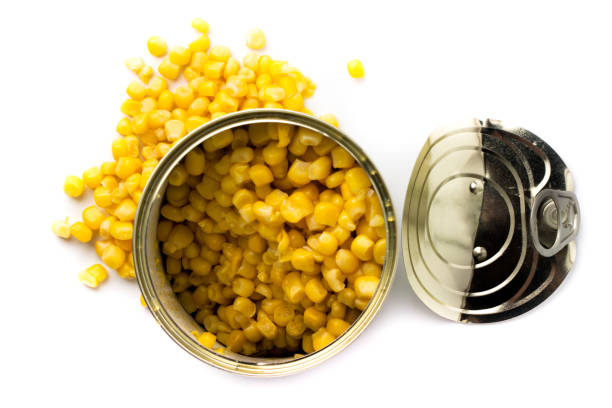 istock Open canned food with corn on a white background. The view from the top. 1129445516