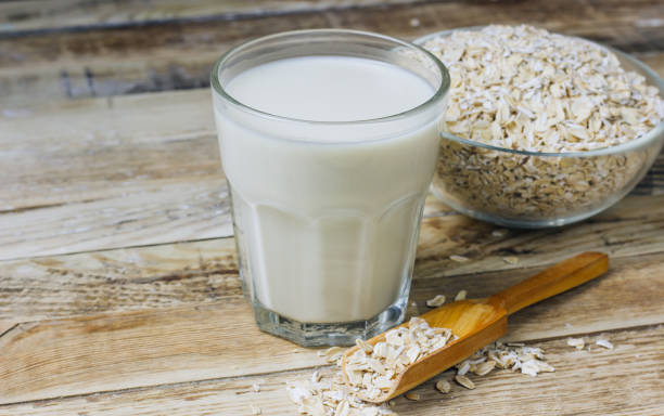 istock Oat milk alternative on rustic wooden background 1129451819