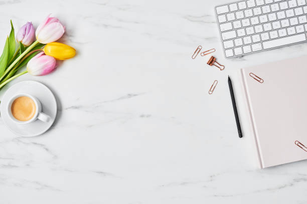 istock Office desk with computer and tulip flowers 1129451981